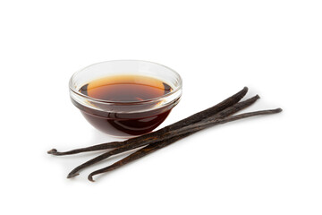 Vanilla extract in glassware isolated on white background. Vanilla extract for baking and desserts. Aromatic Homemade Vanilla Extract. Close -up. Place for the text. Copy space.