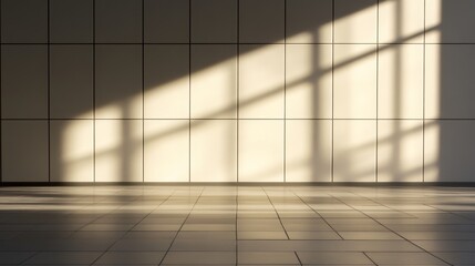 Obraz premium Sunlight casting geometric shadows on a minimalist interior wall with tiled floor