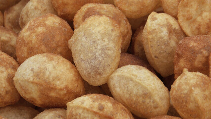 Crispy Indian snack 'Pani puri' displayed in a street food shop