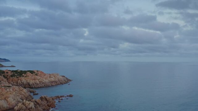 Aerial view of Capo Spartivento and Spiaggia di Cala Cipolla at dusk with calm sea and cloudy weather, Domus de Maria, Sardinia, Italy.