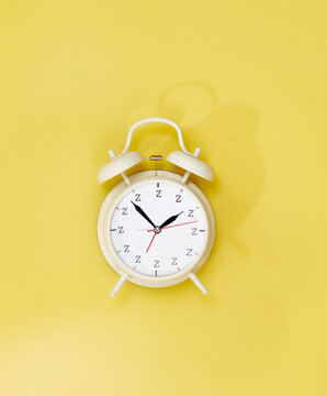 clock alarm sleepy sharp blurred yellow background zzzz funny tired