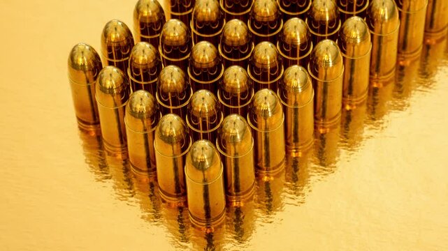 Closeup of 50 9mm pistol cartidges in rows of five on a golden background.