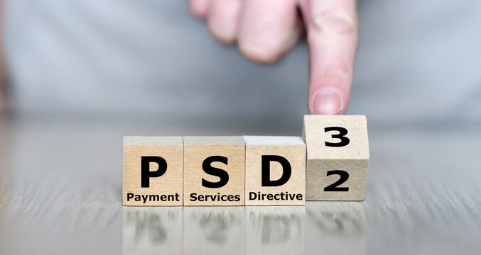 Hand turns cube and changes the expression PSD2 (Payment Services Directive 2) to PSD3 (Payment Services Directive 3).