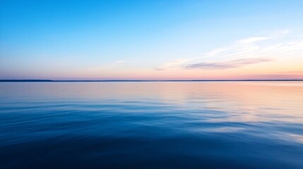 Obraz premium Breathtaking view of the calm ocean at dusk with beautiful reflections and a pastel colored sky : Generative AI