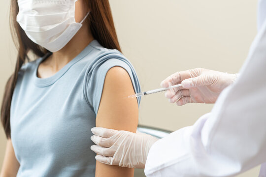 Health care, corona virus, hand of woman nurse, doctor giving syringe vaccine, injection dose on arm sick patient at clinic. Vaccination, immunization disease prevention against flu pandemic influenza