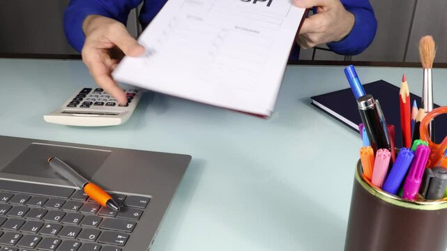 Man shows NASPI (New Social Insurance for Employment) printed model, office desk environment in foreground.