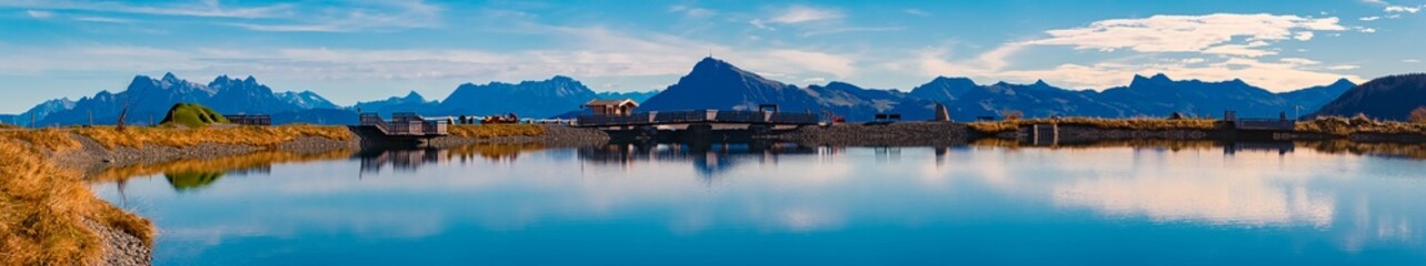 High resolution stitched alpine autumn or indian summer panorama with reflections at Mount...