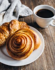 Top View of a Healthy Breakfast Set Featuring Bakery Items and Coffee on a Kitchen Table