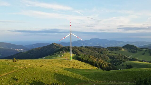 Aerial view of idyllic landscape with windmill and rolling hills in the grazer bergland, Sommeralm, Styria, Austria.