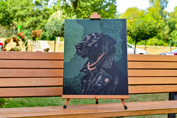 A vibrant painting displayed outdoors, placed on an easel amidst a beautiful natural landscape,...