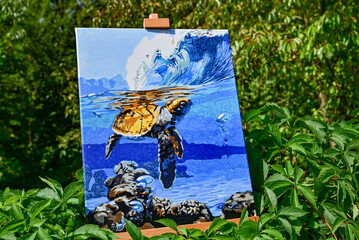 A vibrant painting displayed outdoors, placed on an easel amidst a beautiful natural landscape,...