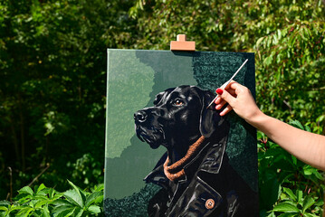 A vibrant painting displayed outdoors, placed on an easel amidst a beautiful natural landscape,...