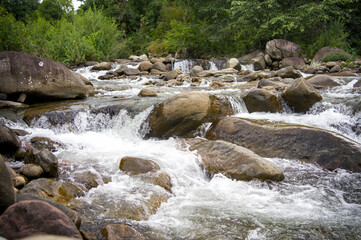 The river flows through the rocks during summer.