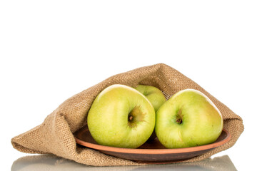 Several sweet green apples with jute bag, close-up, isolated on white background.