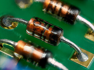 Macro detail of a diode on a green board.
