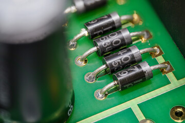 Macro detail of a diode on a green board.
