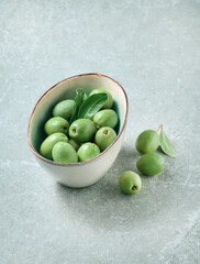 Green olives on gray background