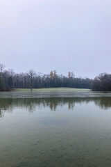 Mystery morning foggy park in the Nymphenburg Palace in Munich, Germany