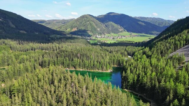 Aerial view of the serene green lake surrounded by lush forest and majestic mountains, Gruner See, Bruck an der Mur, Styria, Austria.