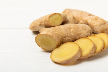 Fresh ginger on wooden background. Dry ginger. Sliced ​​ginger with honey and lemon. Ginger...