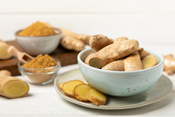 Fresh ginger on wooden background. Dry ginger. Sliced ​​ginger with honey and lemon. Ginger...