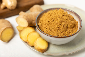 Fresh ginger on wooden background. Dry ginger. Sliced ​​ginger with honey and lemon. Ginger root. Traditional alternative medicine, healing tea for immunity. Seasoning and spices concept. Copy space.