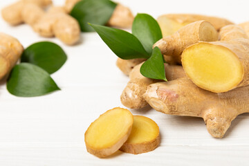 Fresh ginger on wooden background. Dry ginger. Sliced ​​ginger with honey and lemon. Ginger...