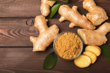 Fresh ginger on wooden background. Dry ginger. Sliced ​​ginger with honey and lemon. Ginger root. Traditional alternative medicine, healing tea for immunity. Seasoning and spices concept. Copy space.