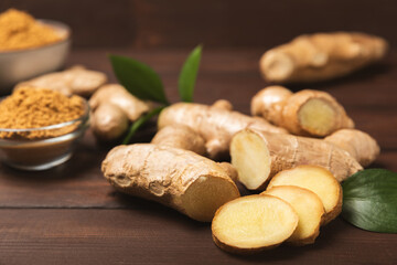 Fresh ginger on wooden background. Dry ginger. Sliced ​​ginger with honey and lemon. Ginger...