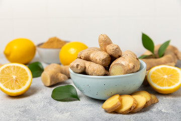 Fresh ginger on wooden background. Dry ginger. Sliced ​​ginger with honey and lemon. Ginger...