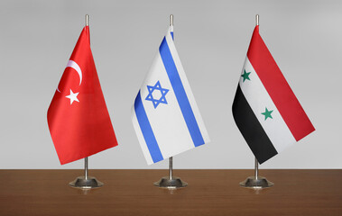 Flags Türkiye, Israel, Syria on a gray blurred background