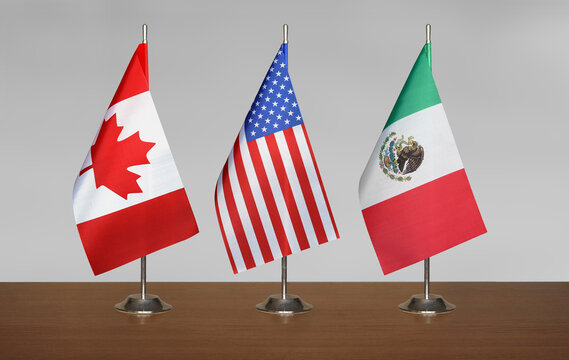 Flags USA, Canada, Mexico on a gray blurred background
