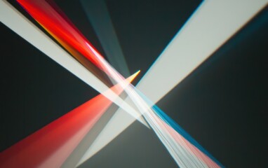 Abstract image featuring intersecting beams of red, white, and blue light against a dark background.  The light creates a dynamic, energetic composition