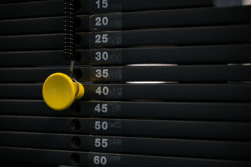 Yellow pin on gym machine weights
