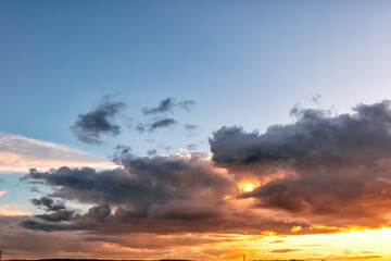 White and gray clouds float across a clear blue sky. For the background of your photos and collages