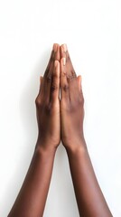 Two hands in a prayer position against a white background, symbolizing peace and spirituality