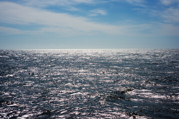 The front view in the morning sky is bright blue with clear white clouds. And the ocean deep indigo in daylight. Feeling calm, cool, relaxing. The idea for cold background and copy space on the top.