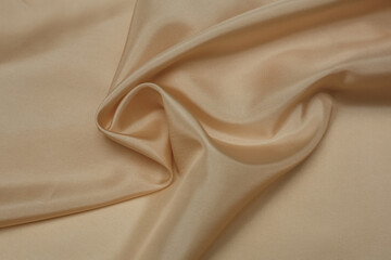 Natural tone beige folded fabric background or texture