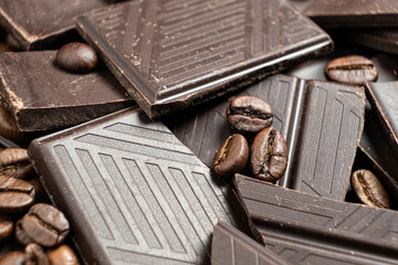 Dark chocolate pieces with coffee beans close-up.