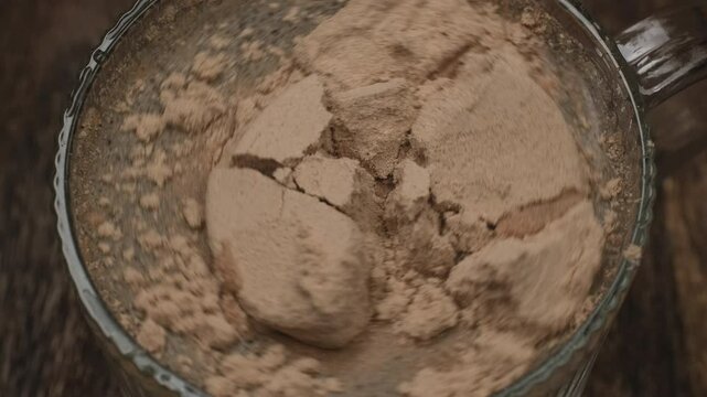 Chocolate protein powder pour into glass with water