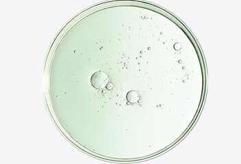 The texture of a cosmetic serum or body gel in a Petri dish.