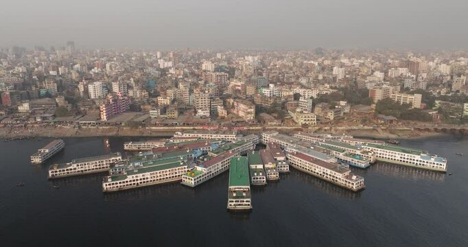 Aerial view of Sadar Ghat with bustling boats along the Buriganga river and dense cityscape, Dhaka, Dhaka Province, Bangladesh.