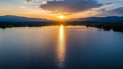 Fototapeta premium Stunning sunset reflecting on tranquil lake waters surrounded by majestic mountains : Generative AI