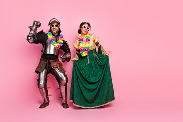 Couple in Medieval Costumes Enjoying a Carnival Party with Colorful Accessories