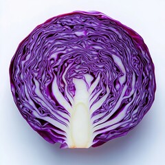 Obraz premium A red cabbage, cut in half, with the inside of one side showing a pattern of purple and white stripes.