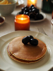 Hygge breakfast. Pancakes, fruits, tea. Cozy Morning