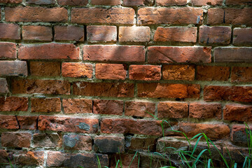 The wall is made of old red brick. Brick background.