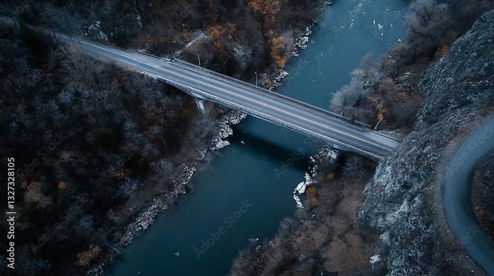 Poster aerial view of a winding bridge crossing a serene river surrounded by autumn foliage showcasing stun