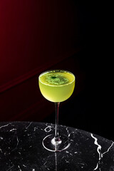 Gin basil smash cocktail in a coupe glass