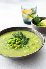 Creamy broccoli and green pea soup with mint, delicious healthy lunch